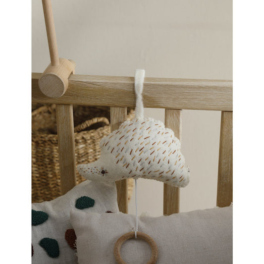 Baby mobile with hanging toy and wooden ring on a crib