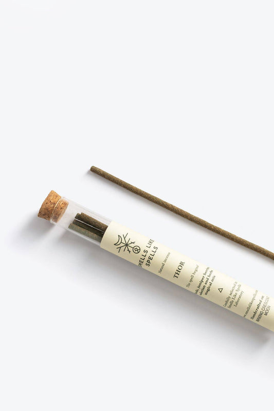 Incense stick with cork lid and white label on a white background