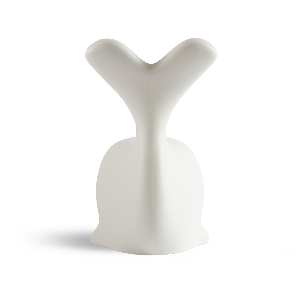 White ceramic whale figurine on a white background