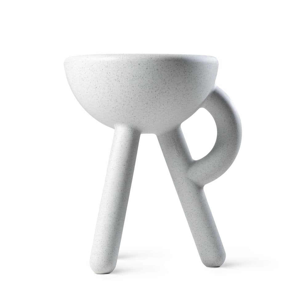 Gray ceramic cup with three legs on a white background