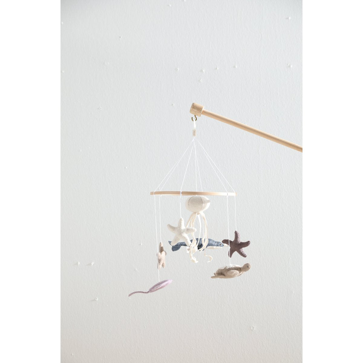 Decorative mobile with seashells and starfish on a white background