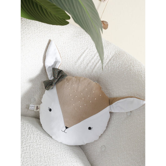 Decorative pillow shaped like a deer with a bow on a textured surface