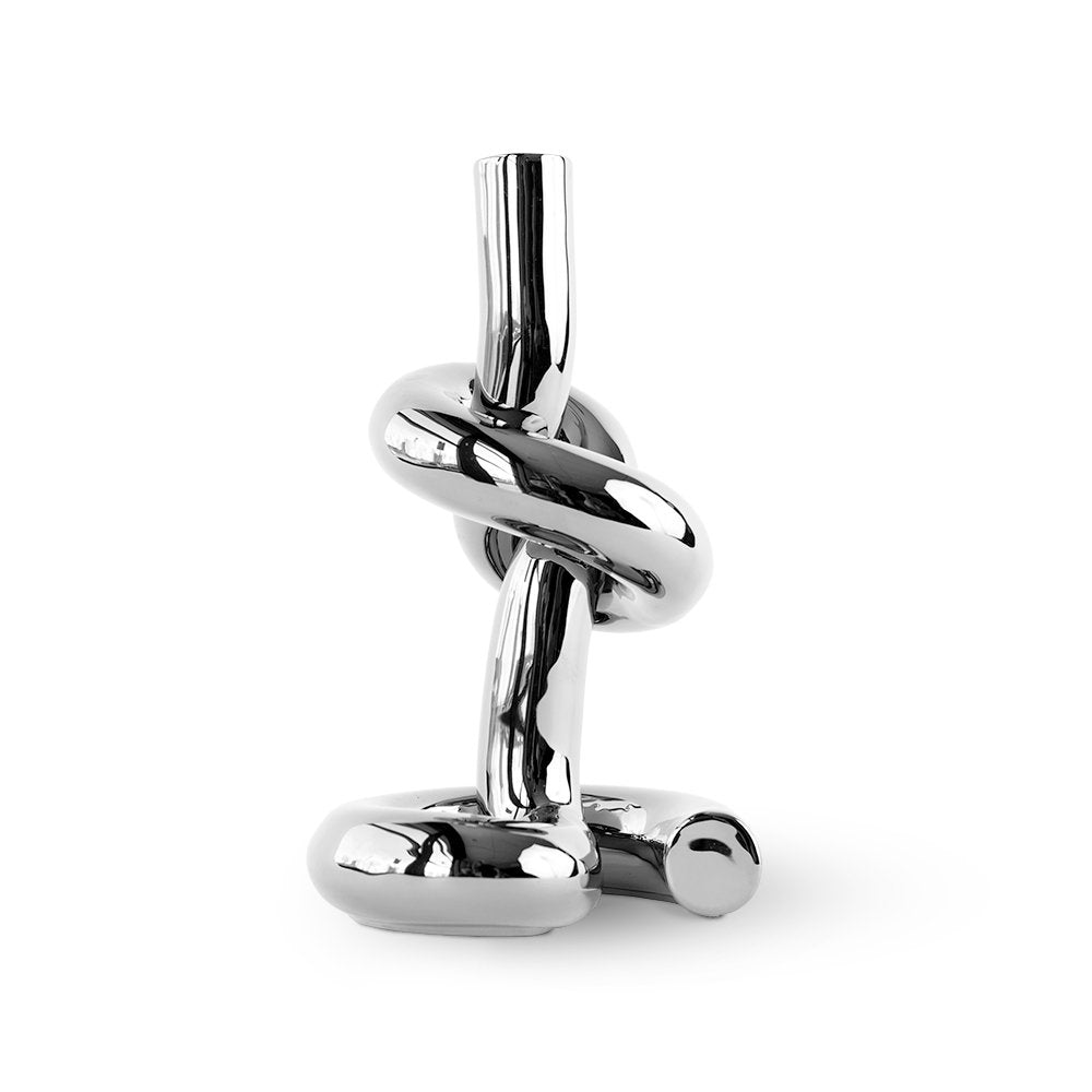Chrome knot-shaped object on a white background