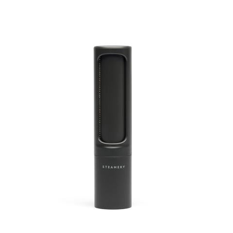 Black lint brush with 'Steamery' branding on a white background
