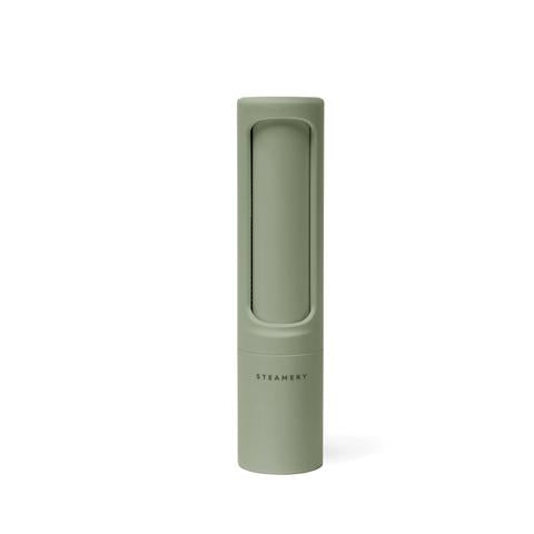 Green pepper grinder on a white background