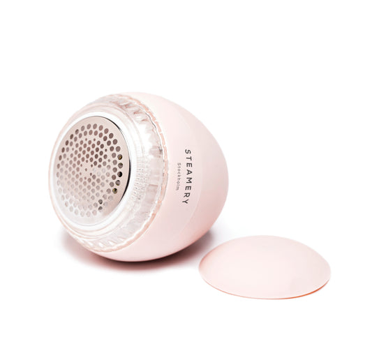 The Pilo Fabric Shaver - Pink is a gentle, yet effective fabric shaver that removes lint and pilling from all kinds of garments.
